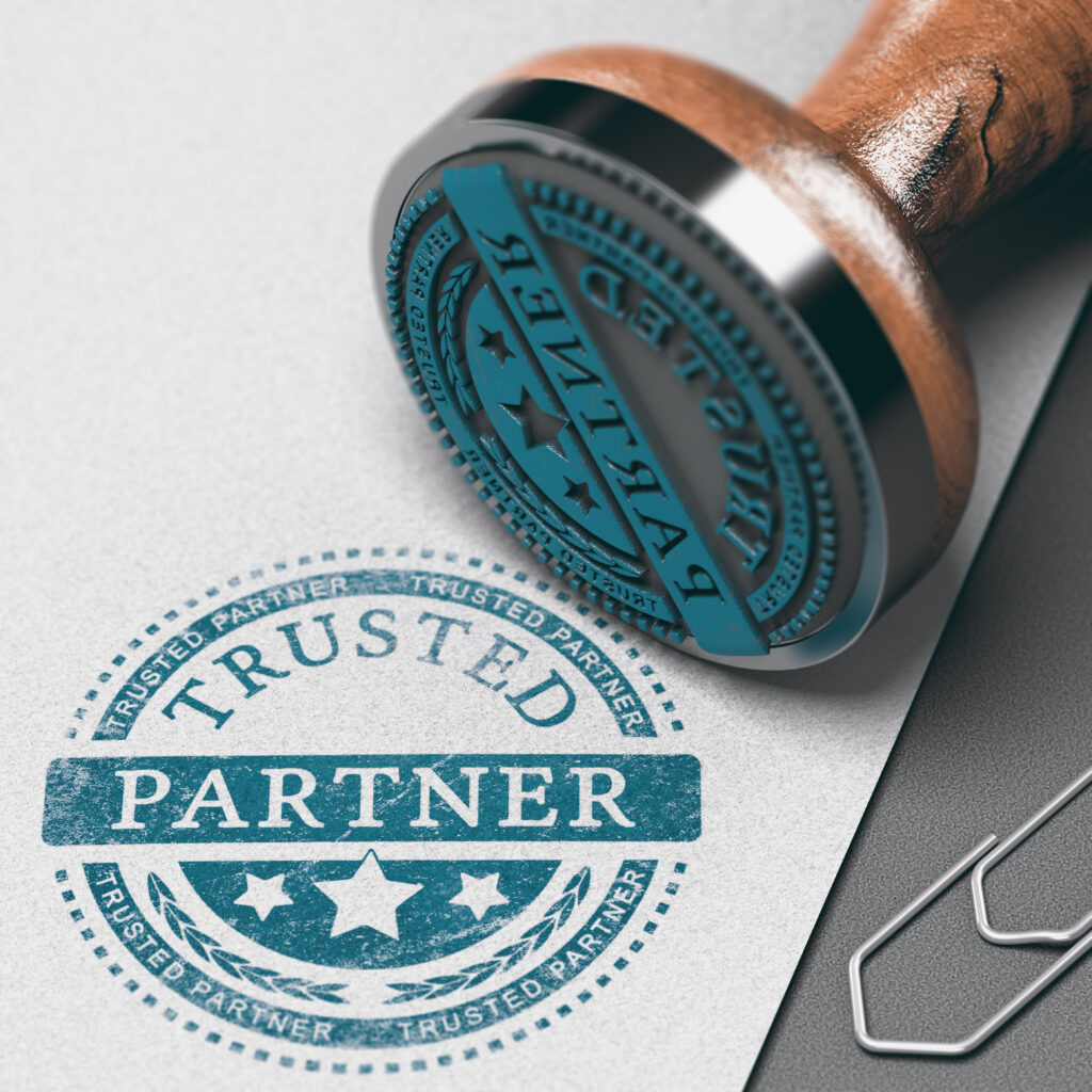 un papier et un tampon avec les mots trusted partner
